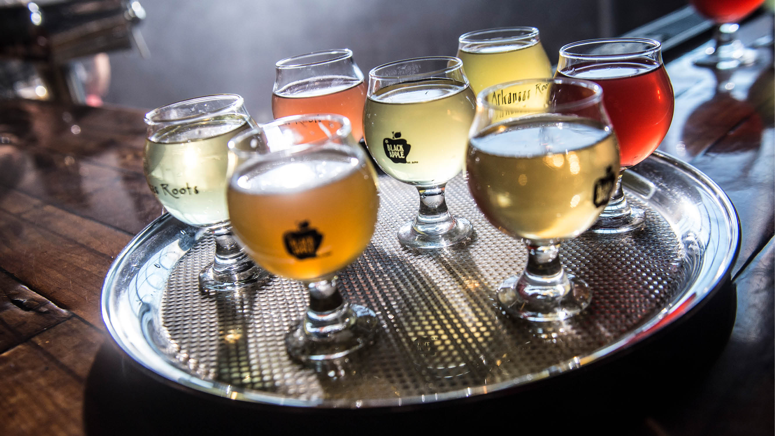 A tray of glasses filled with cider from Black Apple Hard Cider
